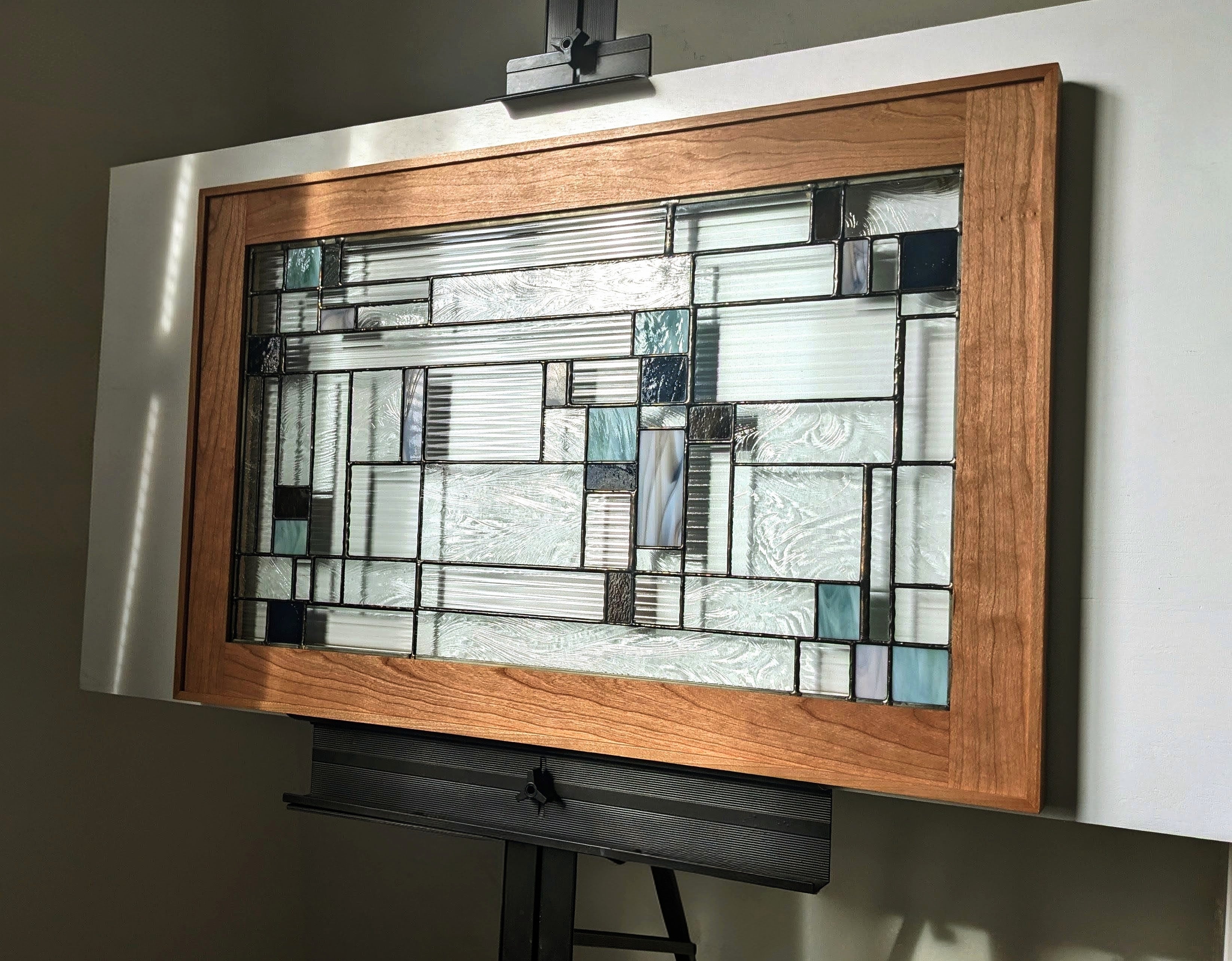 Original stained glass artwork in a cherry wood frame